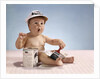 1960s baby with funny facial expression wearing painters cap holding paintbrush sitting by paint can by Anonymous