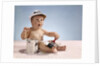 1960s baby with funny facial expression wearing painters cap holding paintbrush sitting by paint can by Anonymous