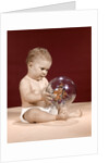 1960s baby sitting holding clear plastic toy ball with butterflies inside by Anonymous