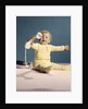 1960s baby holding telephone head set by Anonymous