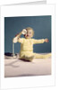 1960s baby holding telephone head set by Anonymous