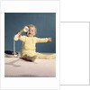 1960s baby holding telephone head set by Anonymous