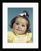1960s brunette baby girl round chubby face yellow dress ribbon topknot interested sincere facial expression looking at camera by Anonymous