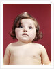 1960s portrait brunette baby girl with chubby round face uncertain facial expression looking at camera by Anonymous