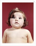 1960s portrait brunette baby girl with chubby round face uncertain facial expression looking at camera by Anonymous