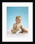 1960s baby sitting holding on to his feet by Anonymous