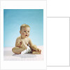 1960s baby sitting holding on to his feet by Anonymous