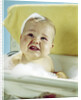 1960s smiling baby in bath looking up by Anonymous