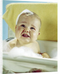 1960s smiling baby in bath looking up by Anonymous
