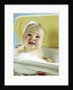 1960s smiling baby in bath looking up by Anonymous