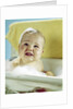 1960s smiling baby in bath looking up by Anonymous