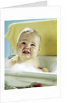 1960s smiling baby in bath looking up by Anonymous