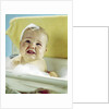 1960s smiling baby in bath looking up by Anonymous