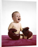 1960s crying baby wearing large boxing gloves by Anonymous