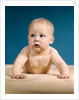 1960s baby big blue eyes raised up on arms looking to side by Anonymous