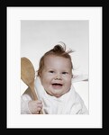 1960s 1970s smiling baby wearing bib and holding wooden spoon by Anonymous