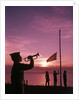 1960s boy scout blowing bugle as others raise american flag at camp sunset ceremony by Anonymous
