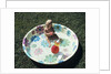 1970s baby sitting in plastic backyard kiddy pool viewed from above by Anonymous
