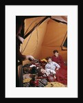 1960s father with lantern checking up on 3 boys in sleeping bags pajamas in tent by Anonymous