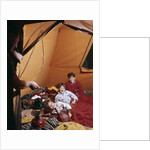 1960s father with lantern checking up on 3 boys in sleeping bags pajamas in tent by Anonymous