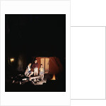 1960s night scene family gazing into campfire by tent by Anonymous