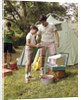 1960s three boys at campsite cooking camp stove eating food tent teens by Anonymous