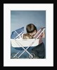1950s 1960s little girl hugging cocker spaniel puppy riding in a baby carriage studio by Anonymous