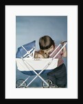 1950s 1960s little girl hugging cocker spaniel puppy riding in a baby carriage studio by Anonymous