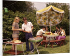 1970s group teenagers boys girls backyard grilling table umbrella by Anonymous
