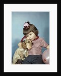 1950s 1960s little girl wearing party hat frowning hugging a cocker spaniel puppy by Anonymous