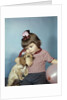 1950s 1960s little girl wearing party hat frowning hugging a cocker spaniel puppy by Anonymous