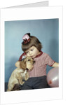 1950s 1960s little girl wearing party hat frowning hugging a cocker spaniel puppy by Anonymous