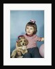 1950s 1960s little girl in party hat sitting holding a cocker spaniel puppy by Anonymous