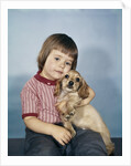 1950s 1960s winsome sad little girl sitting hugging a cocker spaniel puppy studio by Anonymous