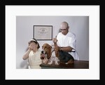 1960s little girl hiding eyes with as pet basset hound gets injection from veterinarian by Anonymous