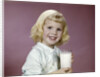 1960s girl glass milk dairy smile looking at camera by Anonymous