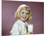 1960s girl glass milk dairy smile looking at camera by Anonymous