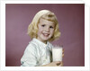 1960s girl glass milk dairy smile looking at camera by Anonymous