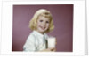1960s girl glass milk dairy smile looking at camera by Anonymous