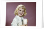 1960s girl glass milk dairy smile looking at camera by Anonymous