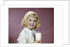 1960s girl glass milk dairy smile looking at camera by Anonymous