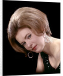 1960s portrait serious woman black sequin evening diamond earrings dress bouffant hairstyle looking at camera by Anonymous