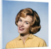 1960s smiling blond woman wearing a yellow sweater head tilted quizzical expression by Anonymous