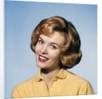 1960s smiling blond woman wearing a yellow sweater head tilted quizzical expression by Anonymous