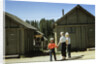 1950s mother and children visiting yellowstone national park wyoming 1956, looking at bear behind cabins by Anonymous