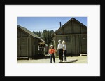 1950s mother and children visiting yellowstone national park wyoming 1956, looking at bear behind cabins by Anonymous