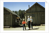 1950s mother and children visiting yellowstone national park wyoming 1956, looking at bear behind cabins by Anonymous