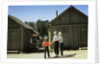 1950s mother and children visiting yellowstone national park wyoming 1956, looking at bear behind cabins by Anonymous