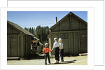 1950s mother and children visiting yellowstone national park wyoming 1956, looking at bear behind cabins by Anonymous
