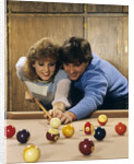 1980s teen couple playing pool by Anonymous